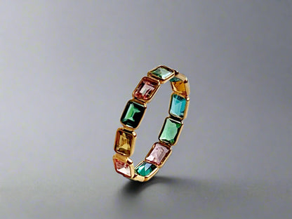Ring with multicolored gemstones on a textured white background